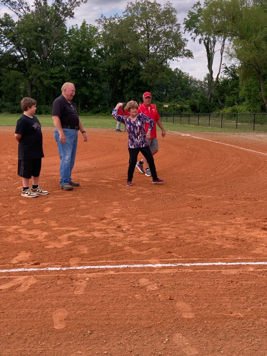 Linda (Hulett) Bond throwing out the first pitch 